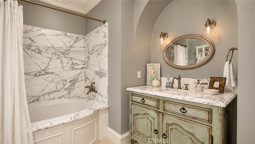 Guest Bath for Bedroom 2, with white slab marble shower walls.