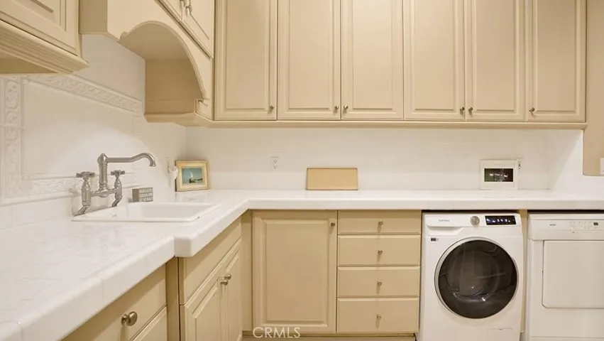 Laundry room. Spacious, with two dryers, lots of storage and countertop space and sink.
