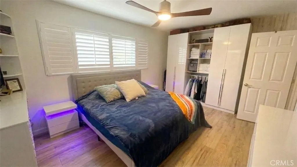 Primary bedroom at 4772 Excelente Drive shown with existing physical furniture and large window.