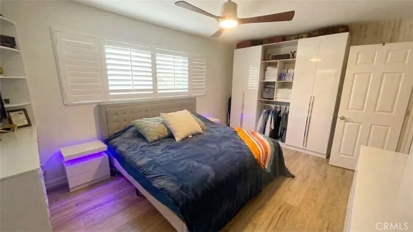 Primary bedroom at 4772 Excelente Drive shown with existing physical furniture and large window.