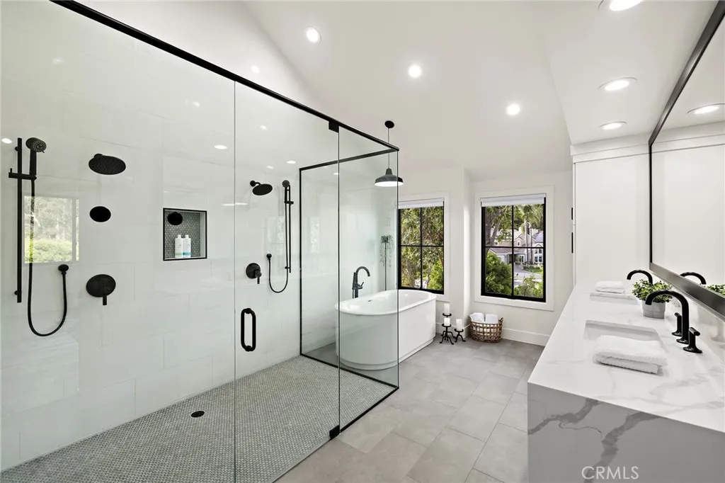 Dual shower heads, soaking tub and dual sinks in primary bathroomn suite