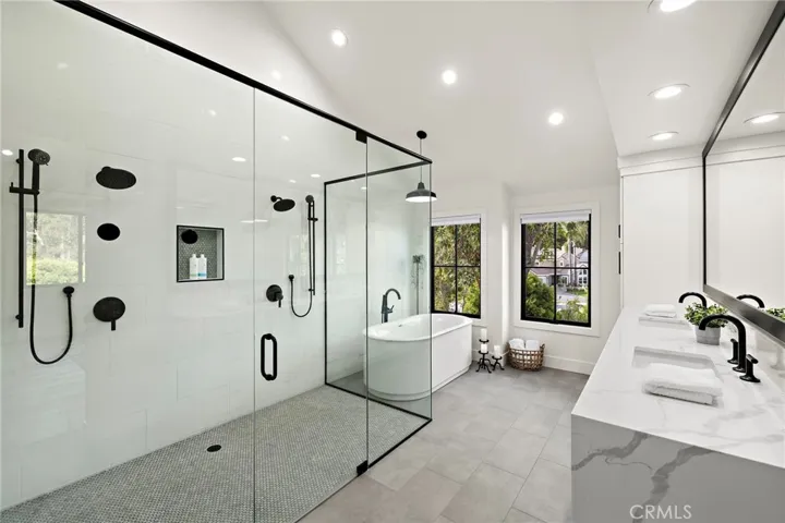 Dual shower heads, soaking tub and dual sinks in primary bathroomn suite