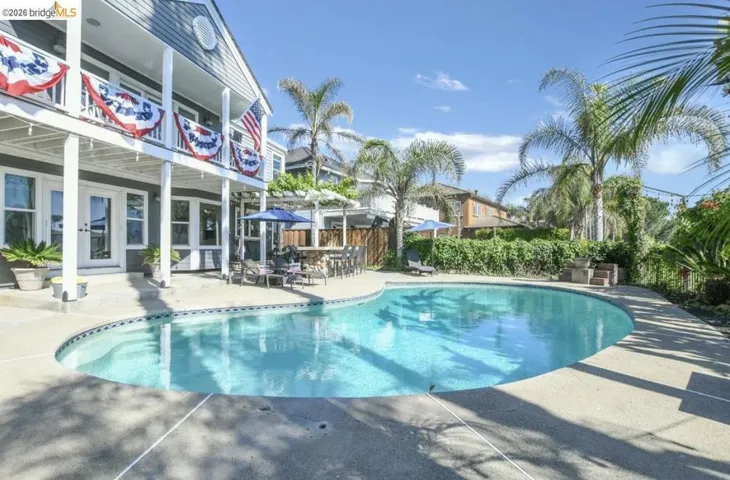 In-ground swimming pool featuring a curved design and integrated steps