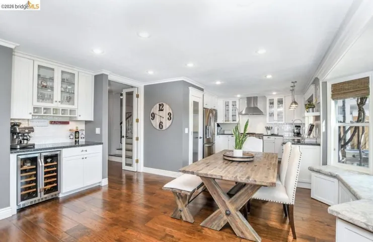 Expansive kitchen and dining area featuring rich wood-finish flooring