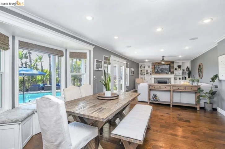 Open-concept living space featuring wood-finish flooring and recessed lighting