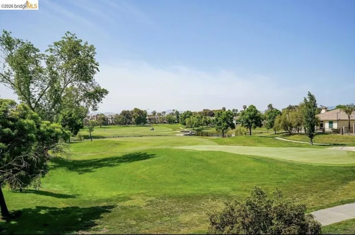 Expansive golf course landscape featuring rolling green fairways and mature trees