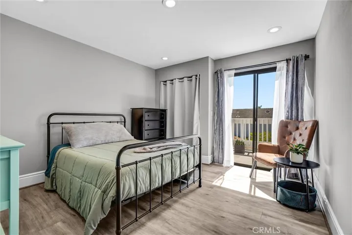 Beautiful secondary bedroom offers sliders to balcony & recessed lighting