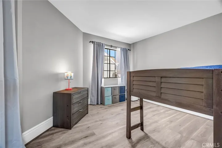 One of the secondary bedrooms, featuring pergo style flooring
