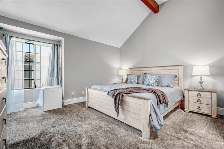 Luxurious Primary suite offers wood-beam ceiling & ample room for all your needs