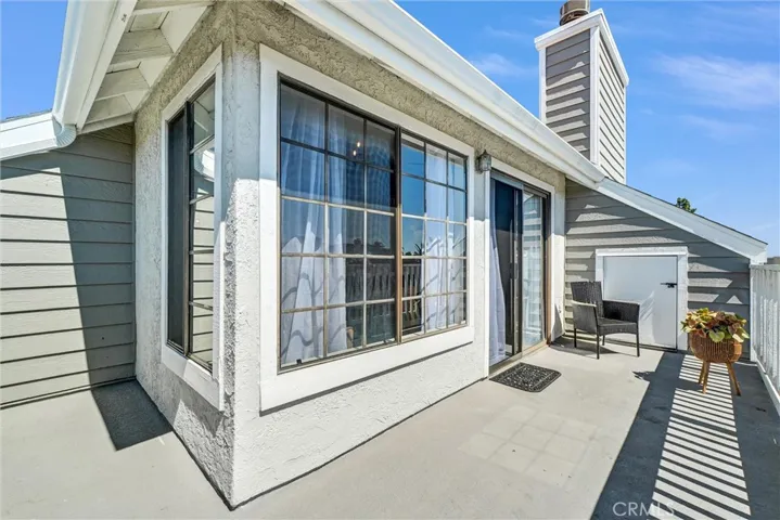 Looking from far end of balcony toward living room & large storage room to right side of photo