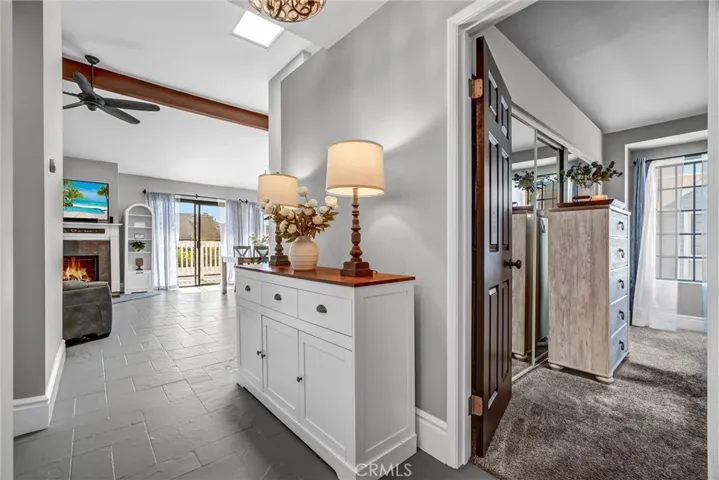Photo looking toward living room and inviting setting with fireplace