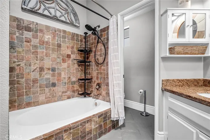 Dramatic stone enclosure for relaxing soaking tub in primary bath