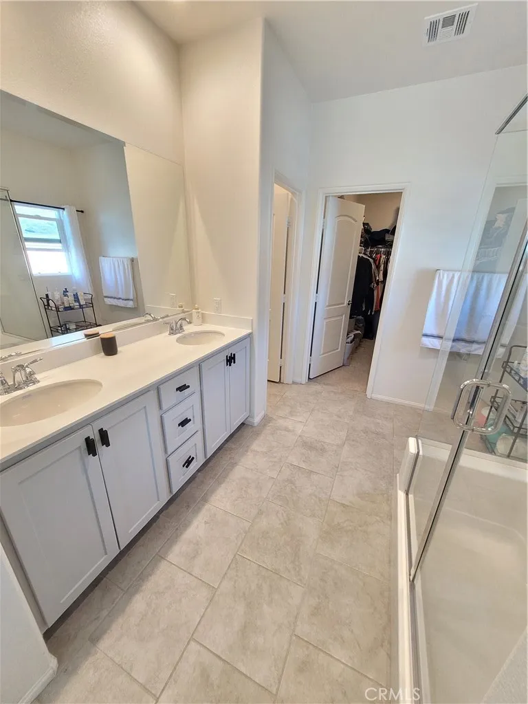 Primary bathroom, double sinks, walk in closet and shower