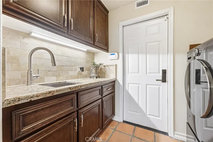Laundry Room with Sink and Door to Garage.