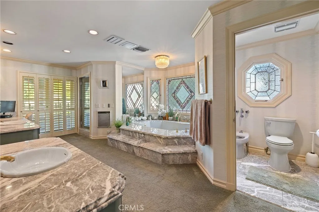 Expansive primary bath with separate jetted bath tub.