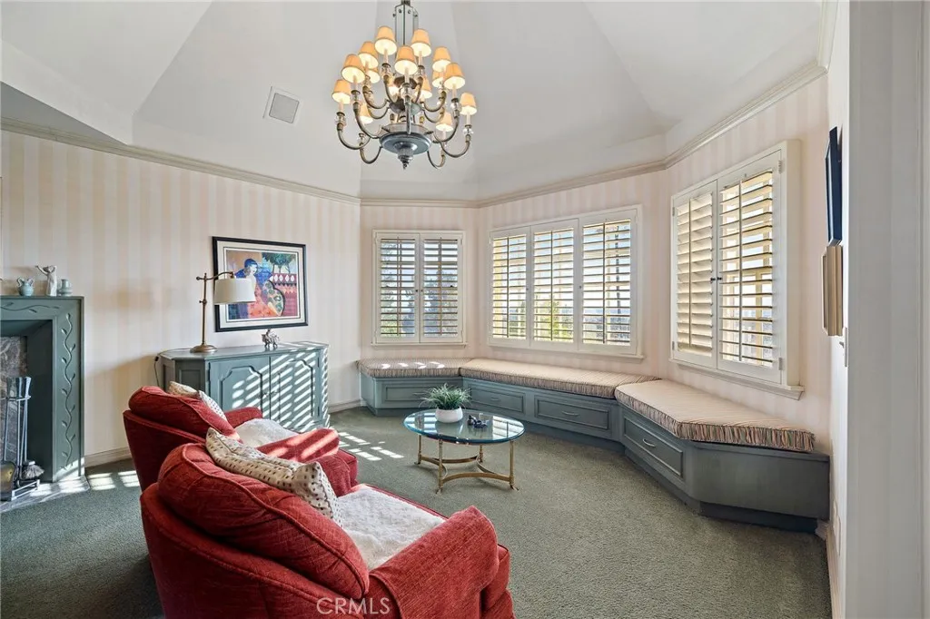 Seating area in primary suite with City-light views!