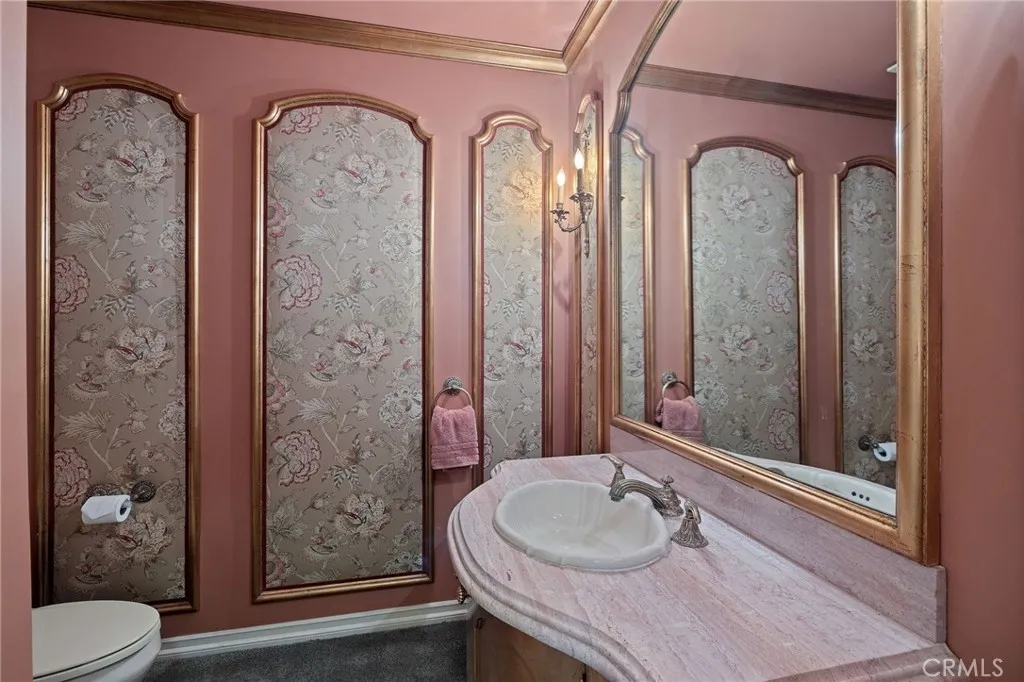 Half bath with 24 karat gold leaf panels/cabinet/light fixtures.