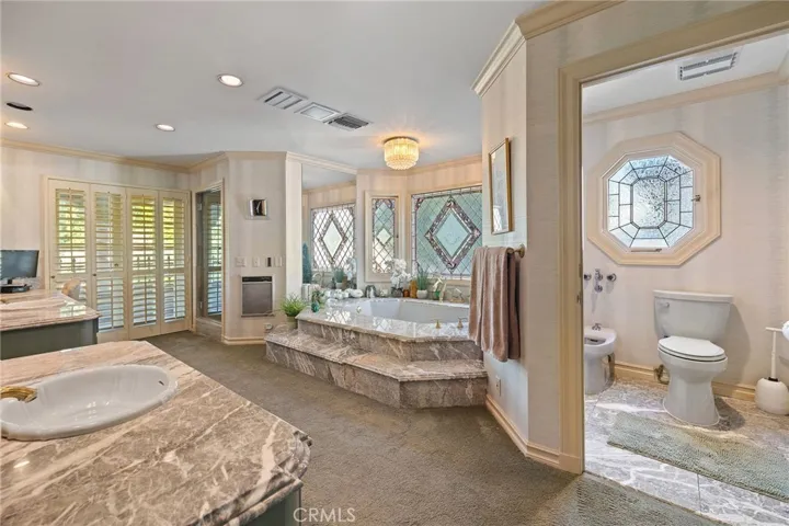 Expansive primary bath with separate jetted bath tub.