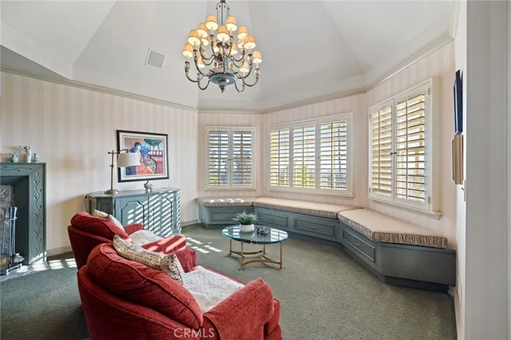 Seating area in primary suite with City-light views!