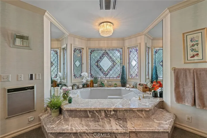 Custom stain glass windows adorn the jetted bath tub.