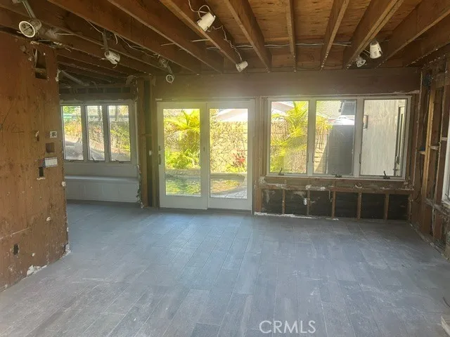 Den or Family Room wit Fireplace # 2 offers two Sliding Doors connecting Pool Area to Fire Table outdoor Bar and BBQ Entertaining Area