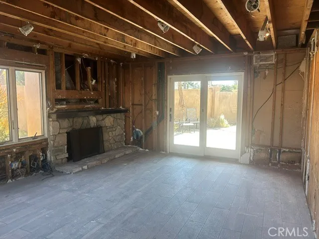 Den or Family Room wit Fireplace # 2 offers two Sliding Doors connecting Pool Area to Fire Table outdoor Bar and BBQ Entertaining Area