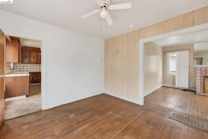 Hardwood flooring extending throughout, with a classic ceiling fan fixture