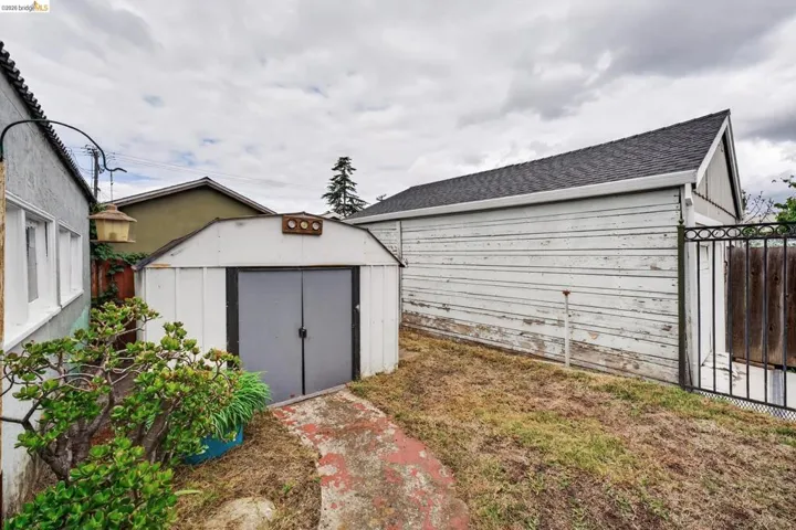 Storage shed with double doors and a sloped roof