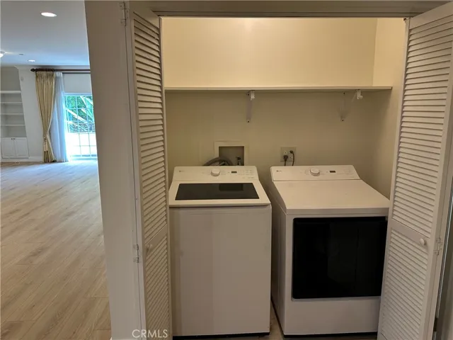 View of the inside laundry area next to the 1/2 of bath