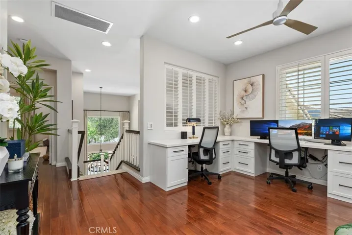 The upstairs office can be enclosed as the 4th bedroom, a builder option. (Computer monitors are virtually enhanced)