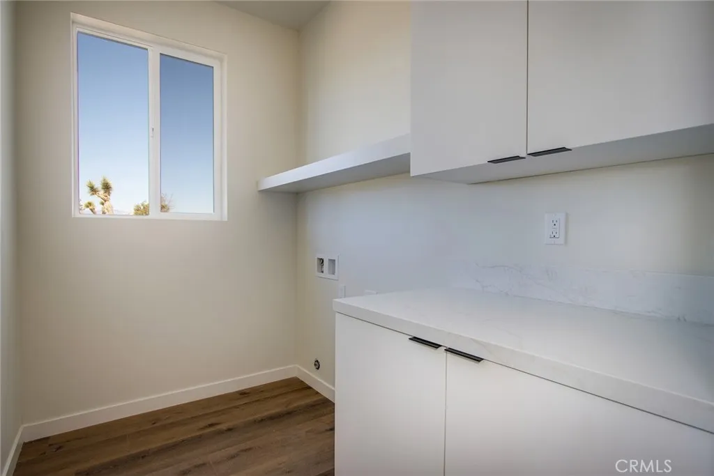 WASHER AND DRYER ROOM WITH LOTS OF CUPBOARDS!