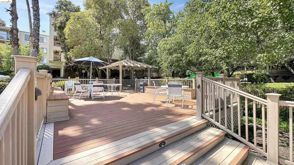 Multi-level wood-finish deck featuring integrated steps and a matching railing system