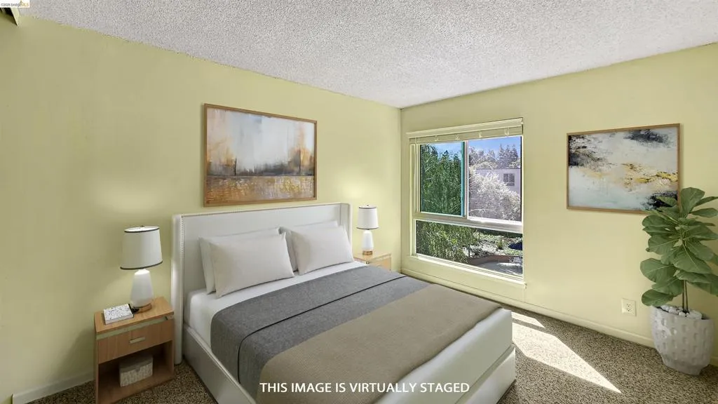 Spacious room featuring light yellow walls and textured carpeting
