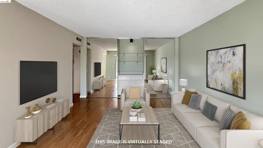 Open concept living area featuring wood-finish flooring throughout