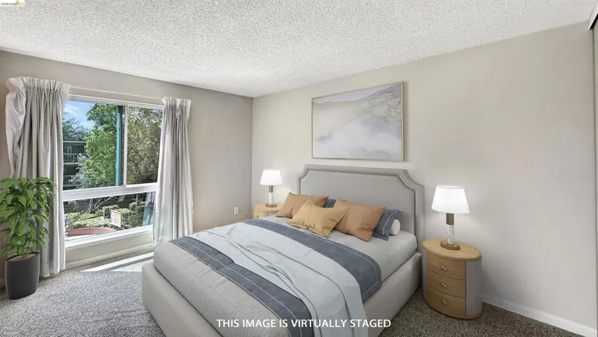 Bedroom featuring a large picture window, neutral wall paint, and textured ceiling