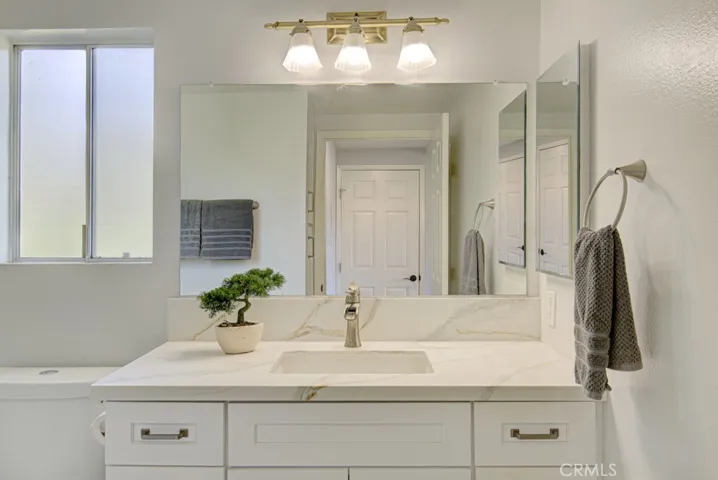 Fresh and clean Primary Bathroom has Shaker Style Vanity and thick quartz contertop.