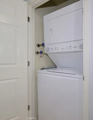 The washer and dryer are conveniently located in the hall.