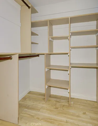 The spacious walk in closet features built in closet organizers.