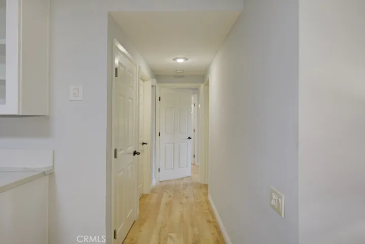 Pretty paneled doors and gleaming laminate floors welcome you to the bedrooms and bathrooms. Pretty paneled doors accent the wide baseboards and newer laminate floors.