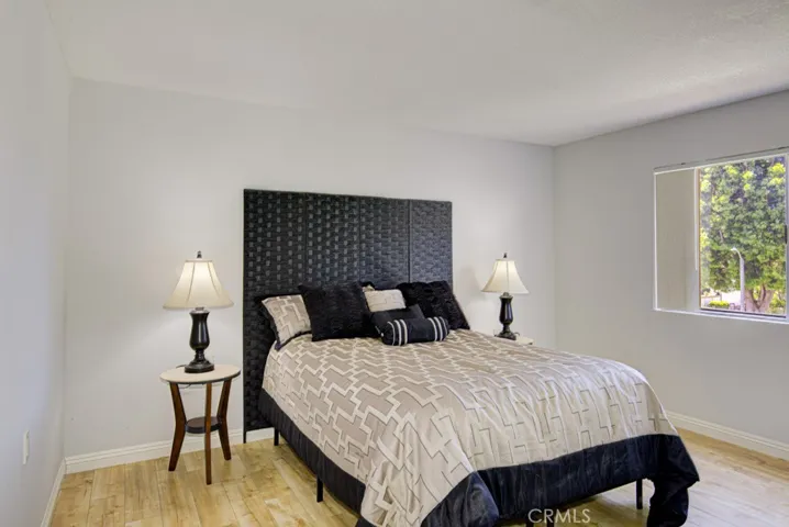 The spacious Primary Suite looks out to lush foliage.  The bed in the photo is a queen size.  The room easily acconmodates a king size bed, large dresser and large bedside tables.