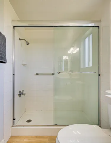 The Primary Bathroom has a large, step-in shower with glass enclosure.