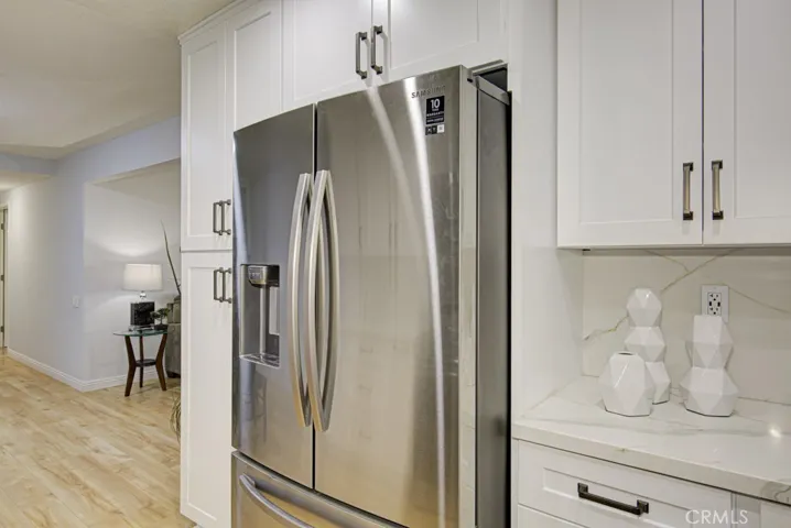 There's a nice cabinet on the right side of the fridge for even more storage and work space.  The pantry on the left of the fridge offers additional storage space.