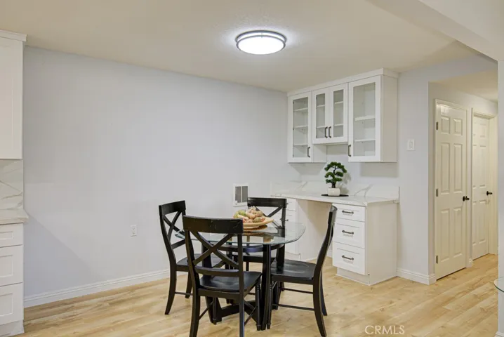 The dining room has a beautiful built in desk and glass front cabinets above.