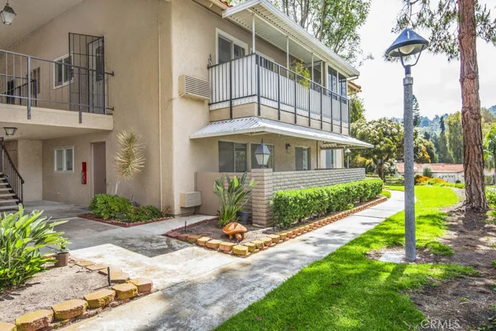 Ground floor entry.  Take the sidewalk or the stairs to the carport.