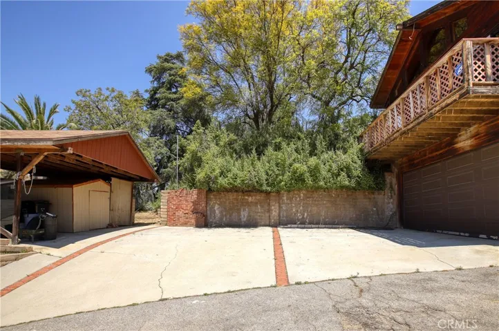 Parking area between covered storage area and 2 car garage