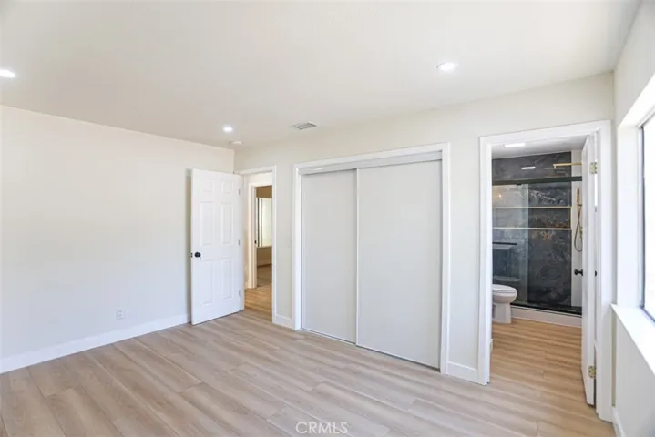 Large primary bedroom with updated finishes and comfortable layout.