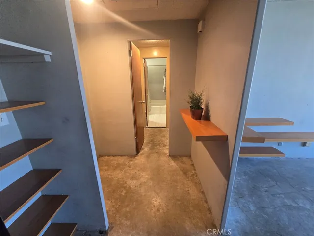 Entry foyer leading to closet with bathroom beyond