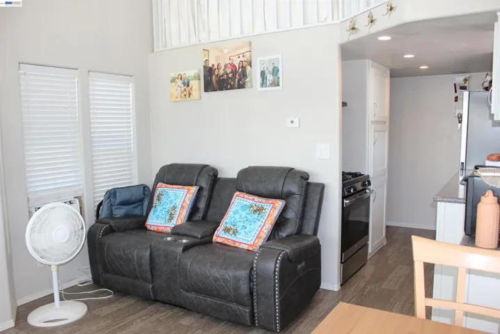 Living room from a different side.  Shows entrance to kitchen.