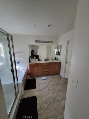 In Suite Restroom with Separate Shower and Bathtub. Double sink.
