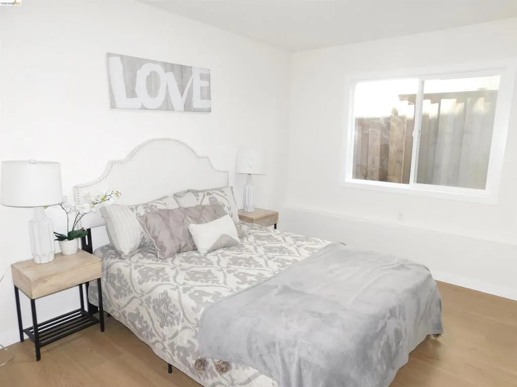 Light wood-finish flooring complements the neutral wall color